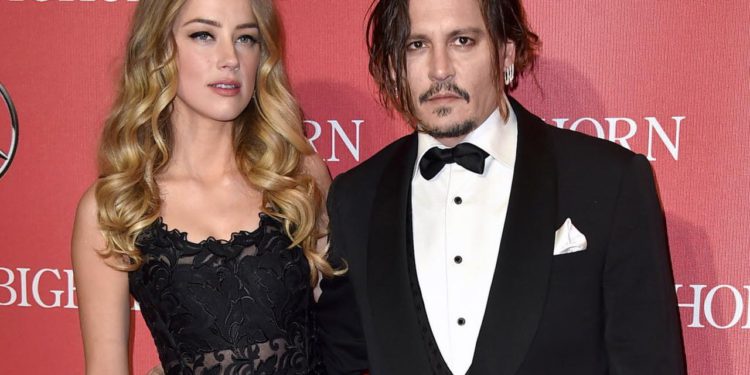 FILE - In this Jan. 2, 2016 file photo, Amber Heard, left, and Johnny Depp arrive at the 27th annual Palm Springs International Film Festival Awards Gala in Palm Springs, Calif. Court records show Heard filed for divorce in Los Angeles Superior Court on Monday, May 23, 2016, citing irreconcilable differences. The pair were married in February 2015 and have no children together. (Photo by Jordan Strauss/Invision/AP, File)