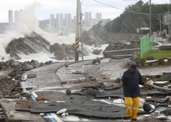 A man walks on a road along the coast damaged by Typhoon Hinnamnor in Ulsan, South Korea, September 6, 2022.    Yonhap via REUTERS   ATTENTION EDITORS - THIS IMAGE HAS BEEN SUPPLIED BY A THIRD PARTY. SOUTH KOREA OUT. NO RESALES. NO ARCHIVE.     TPX IMAGES OF THE DAY