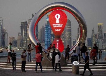 FILE - People gather around the official countdown clock showing remaining time until the kick-off of the World Cup 2022, in Doha, Qatar, Thursday, Nov. 25, 2021. Qatar will host the 2022 FIFA World Cup but soccer isn't the only sport played in the Gulf Arab country. From traditional pursuits to worldwide competitions, Qatar increasingly has marketed itself as a host for sports of all sorts. (AP Photo/Darko Bandic, File)