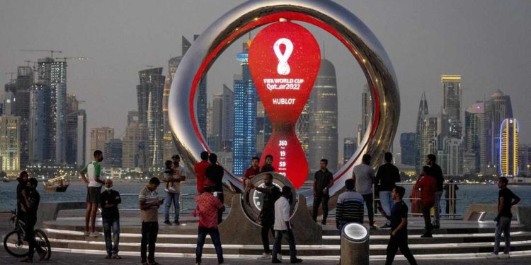 FILE - People gather around the official countdown clock showing remaining time until the kick-off of the World Cup 2022, in Doha, Qatar, Thursday, Nov. 25, 2021. Qatar will host the 2022 FIFA World Cup but soccer isn't the only sport played in the Gulf Arab country. From traditional pursuits to worldwide competitions, Qatar increasingly has marketed itself as a host for sports of all sorts. (AP Photo/Darko Bandic, File)